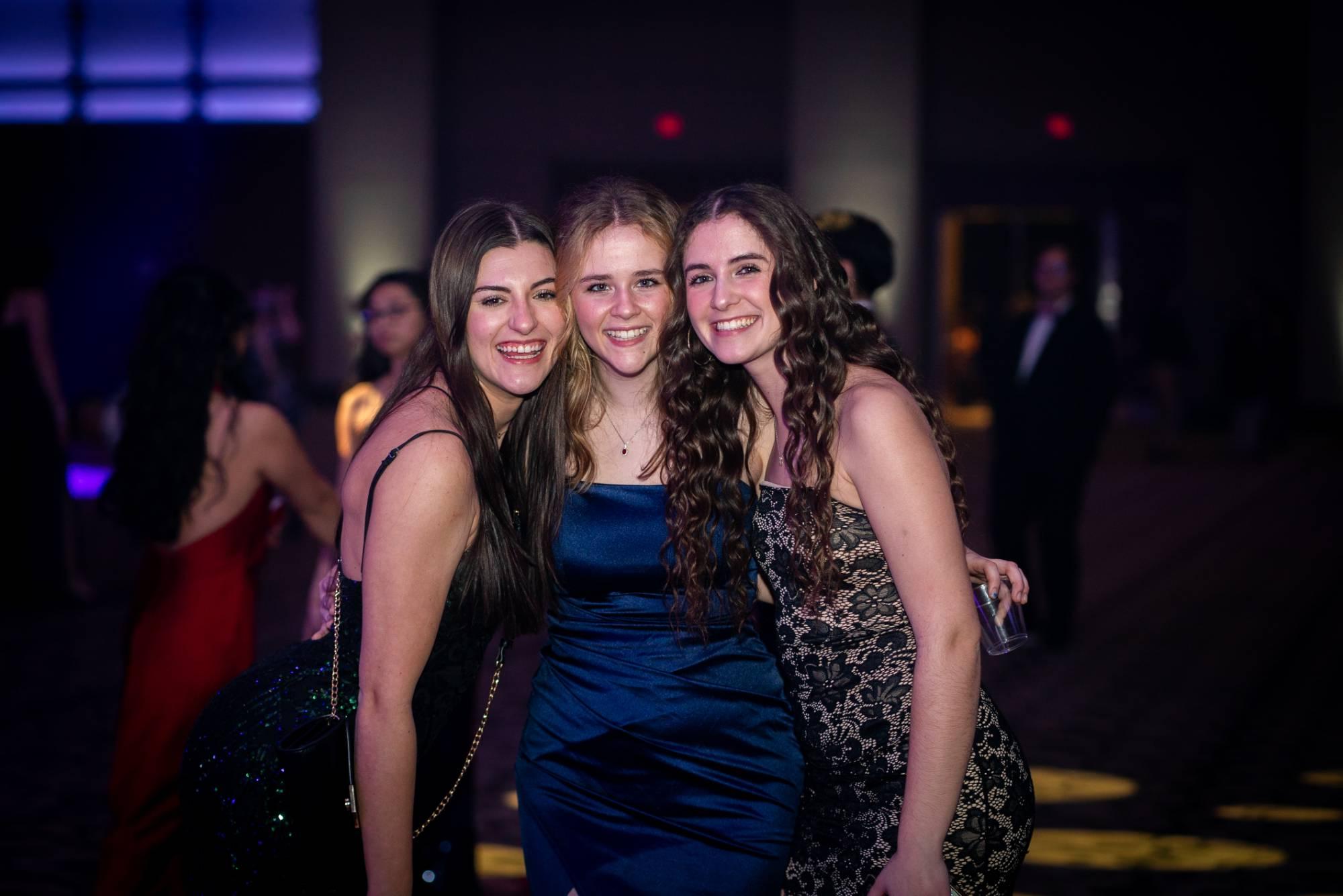 3 women smiling for photo at presidents' ball